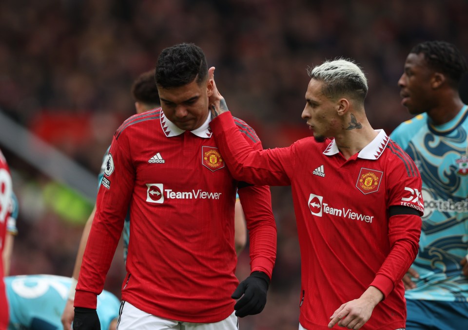 Two Manchester United soccer players in red uniforms.