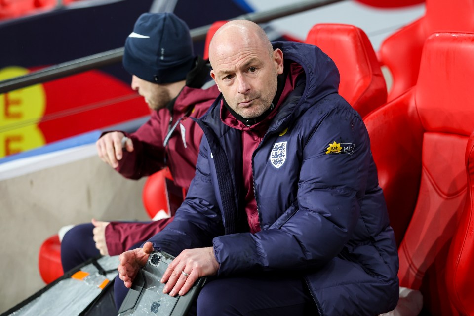 Lee Carsley, interim head coach of England, sits in the stands.