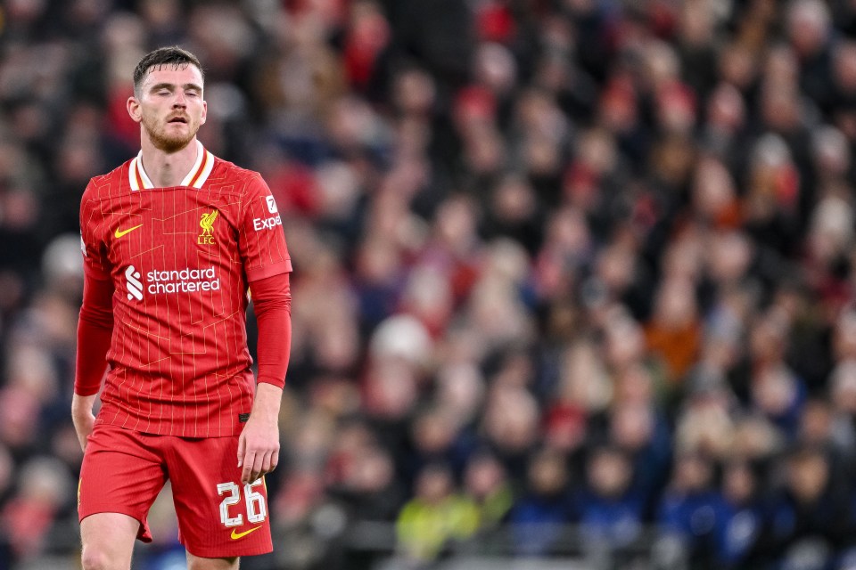 Andy Robertson of Liverpool FC looking dejected during a soccer match.