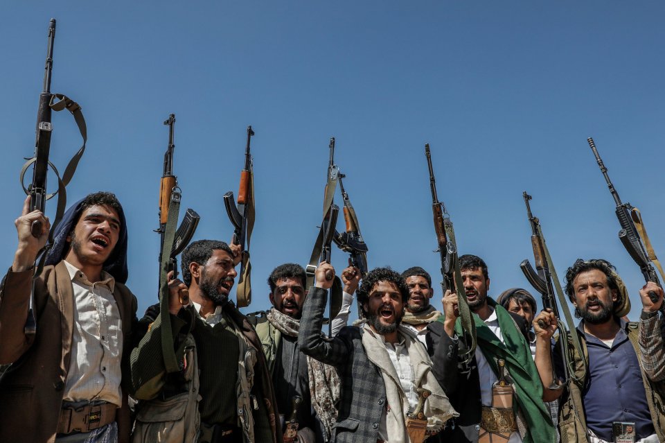 Armed Houthi rebels in Yemen demonstrate against the USA and Israel.