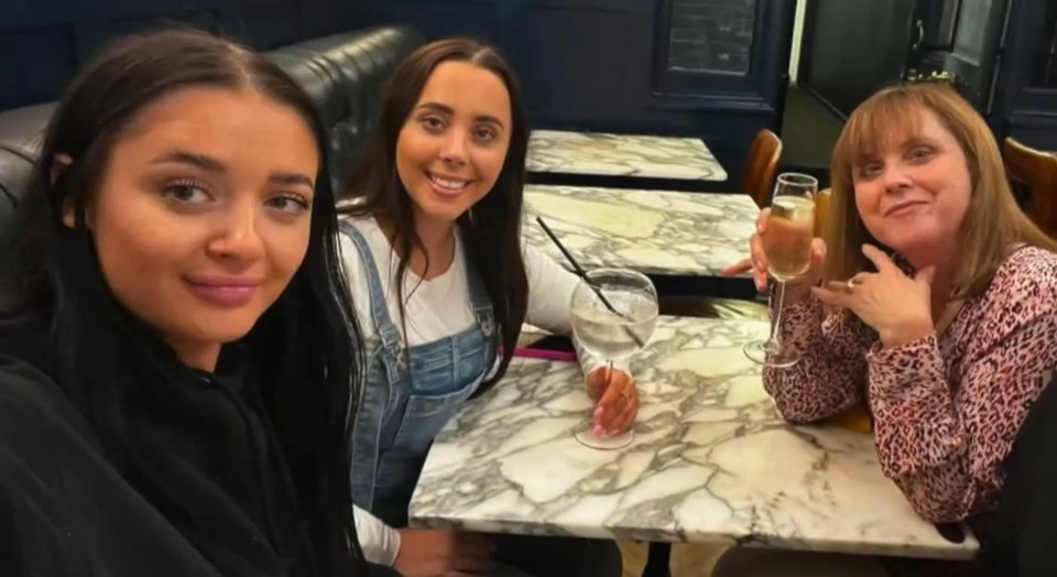 Photo of three women sitting at a table in a restaurant.