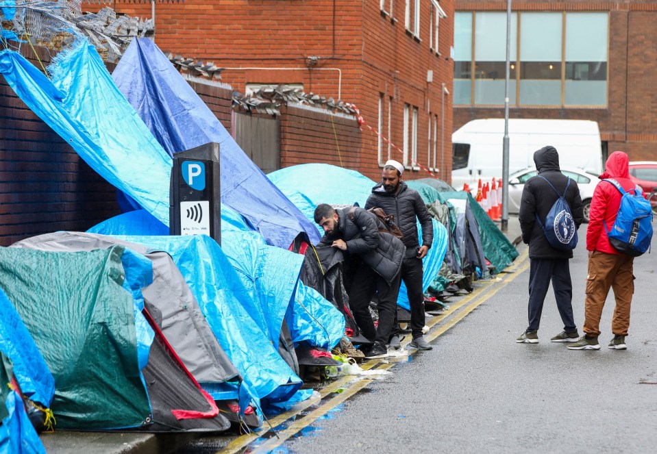 Migrants and asylum seekers near the International Protection Office in Dublin, Ireland, living in tents.