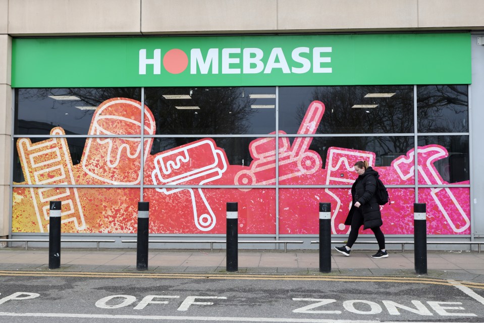 A woman walks past a closed Homebase store in London.