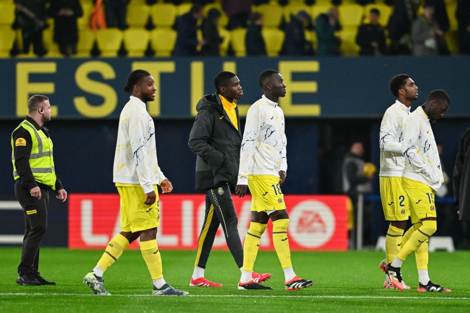 Villarreal soccer players leaving the field after a match postponement.