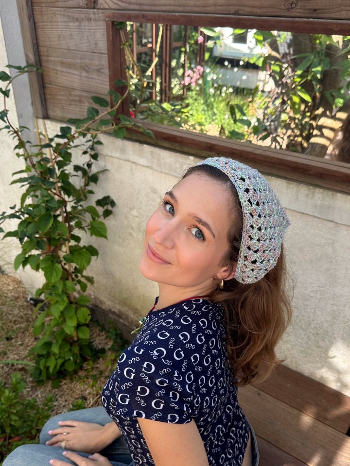 Woman wearing a crocheted headband.