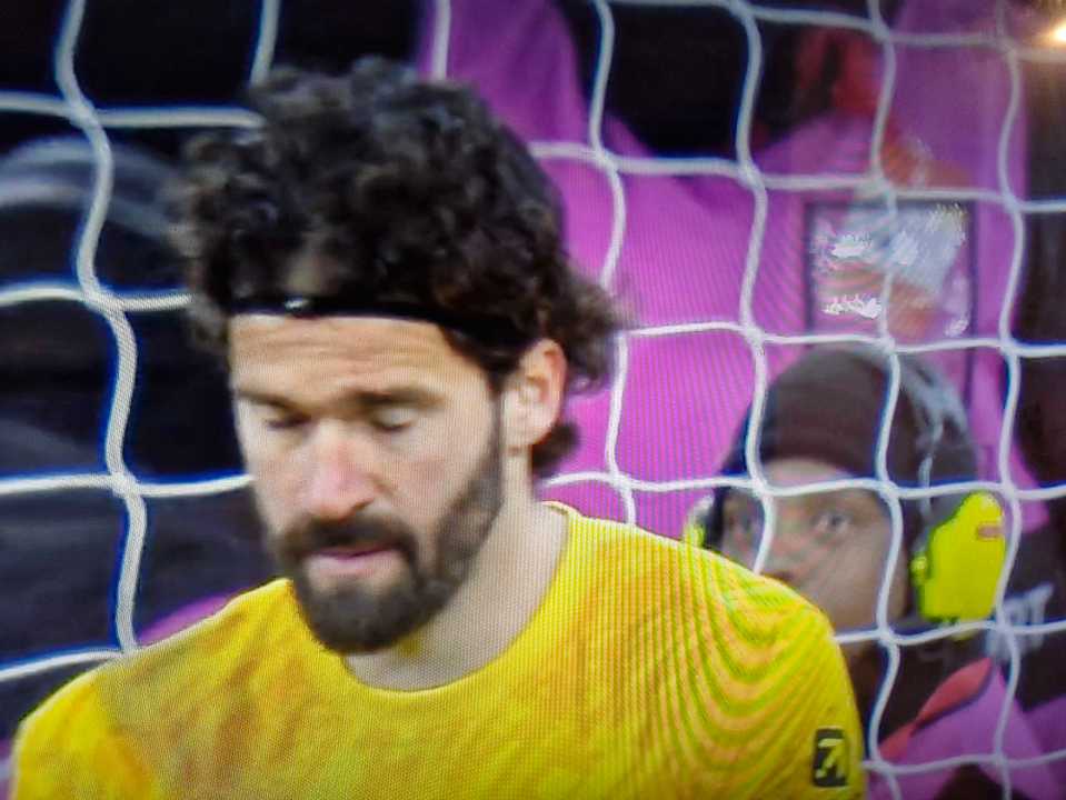 Close-up of a soccer goalie looking down.
