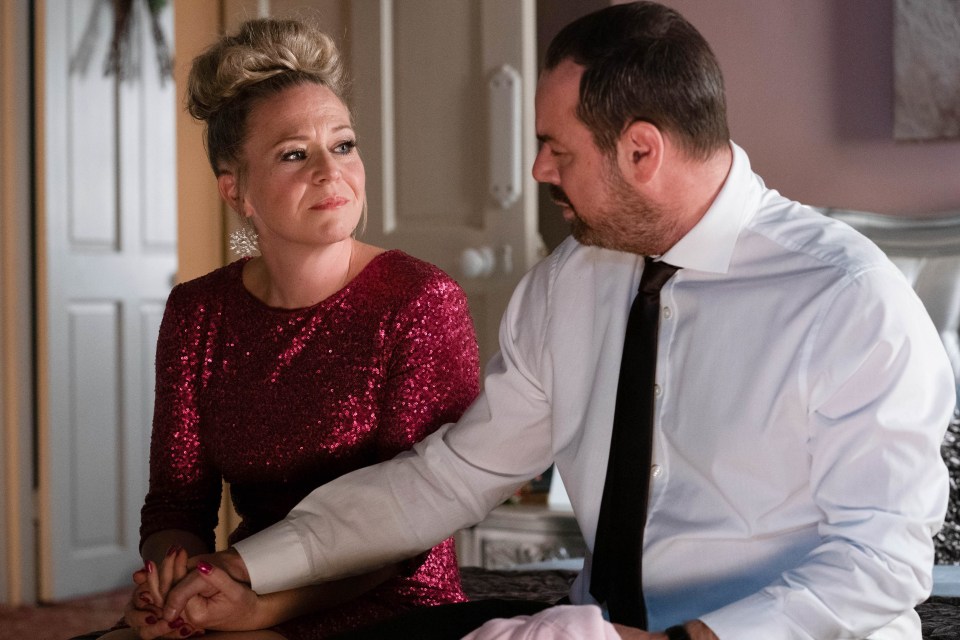 Linda Carter and Mick Carter from EastEnders holding hands.