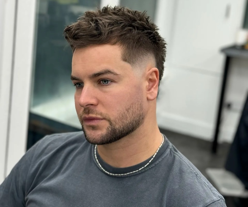 Man with short, textured hairstyle.