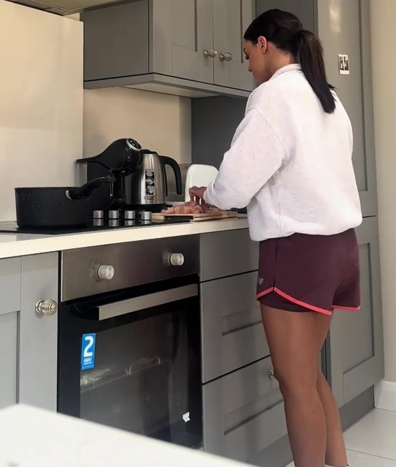 Woman preparing food in a kitchen.
