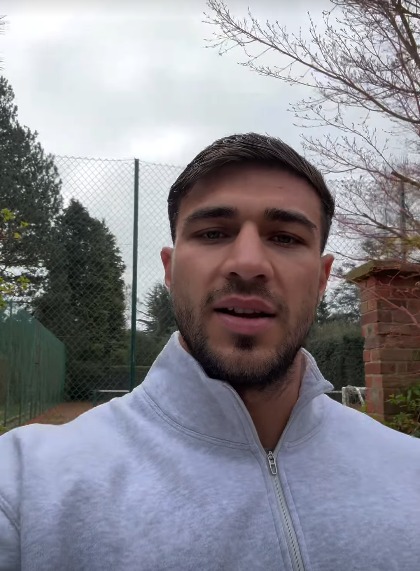 Man speaking to camera outdoors.