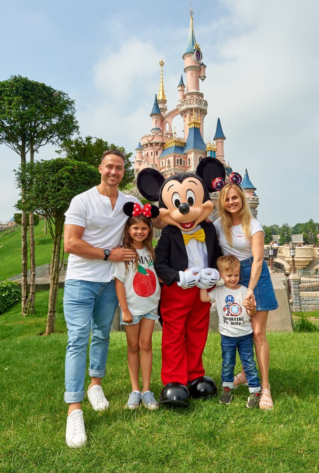 Family with Mickey Mouse at Disneyland Paris.