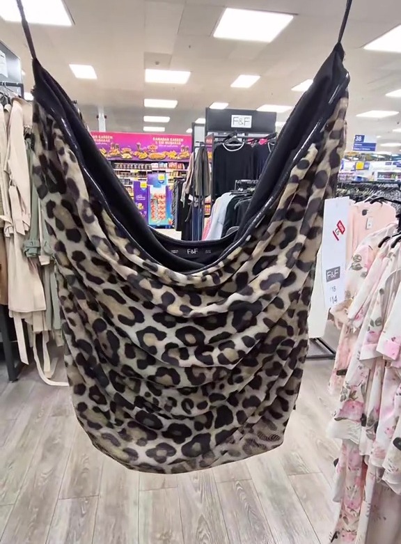 Leopard print top hanging in a store.