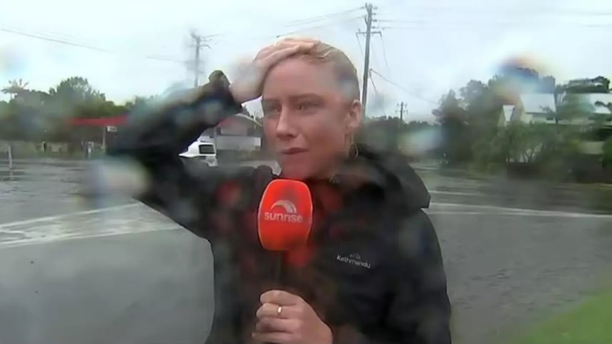 Reporter reporting in heavy rain.
