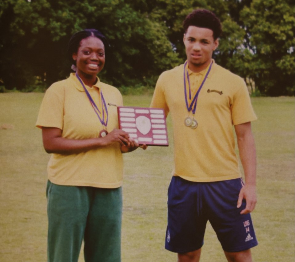 Two students holding an award.