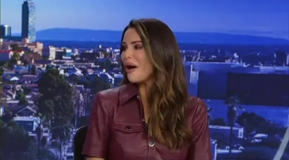 Screenshot of a TV presenter slipping and falling live on air.