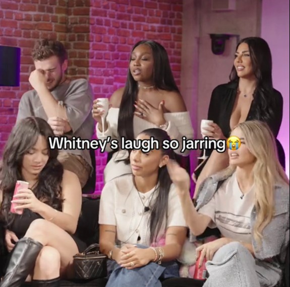 Screenshot of a group of women reacting to Whitney's laugh.