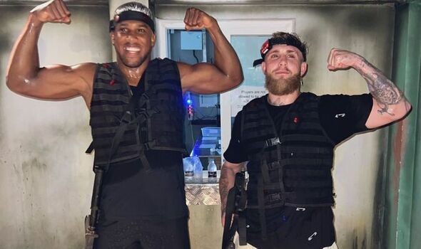 Anthony Joshua and Jake Paul flexing in laser tag vests.