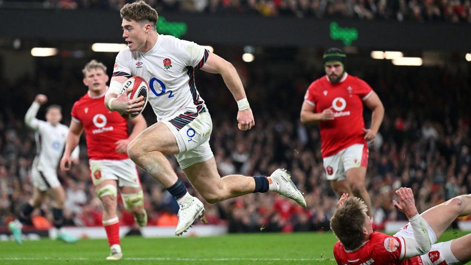 Rugby player running with the ball during a match.