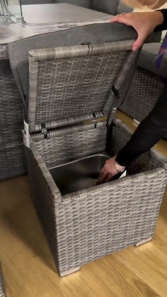 Wicker storage ottoman with lift-top lid and removable ice bucket.