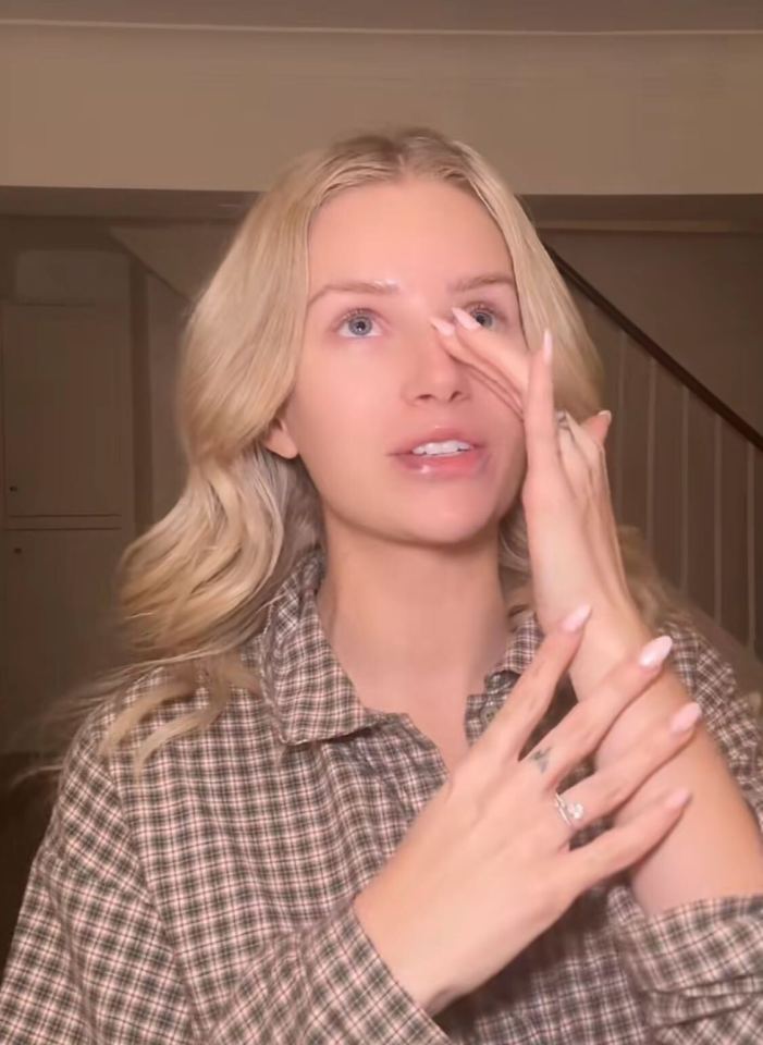 Woman demonstrating skincare routine.