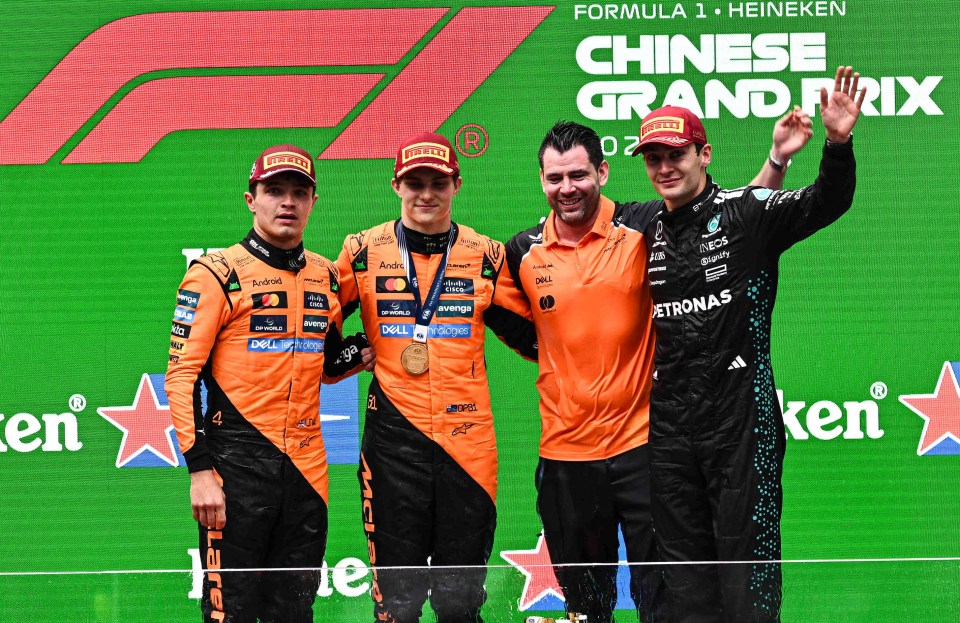 SHANGHAI, CHINA - MARCH 23: Second placed Lando Norris (L) of Great Britain and McLaren, race winner Oscar Piastri (2nd L) of Australia and McLaren, and third placed George Russell (R) of Great Britain and Mercedes AMG Petronas F1 Team on the podium during the F1 Grand Prix of China at Shanghai International Circuit on March 23, 2025 in Shanghai, China. (Photo by John Ricky/Anadolu via Getty Images)