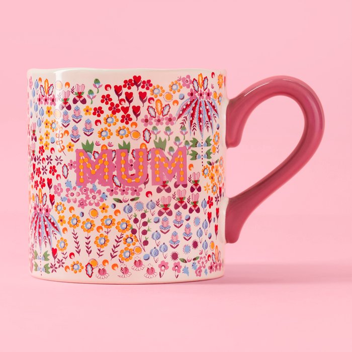 Mug with floral pattern and "Mum" in pink lettering.