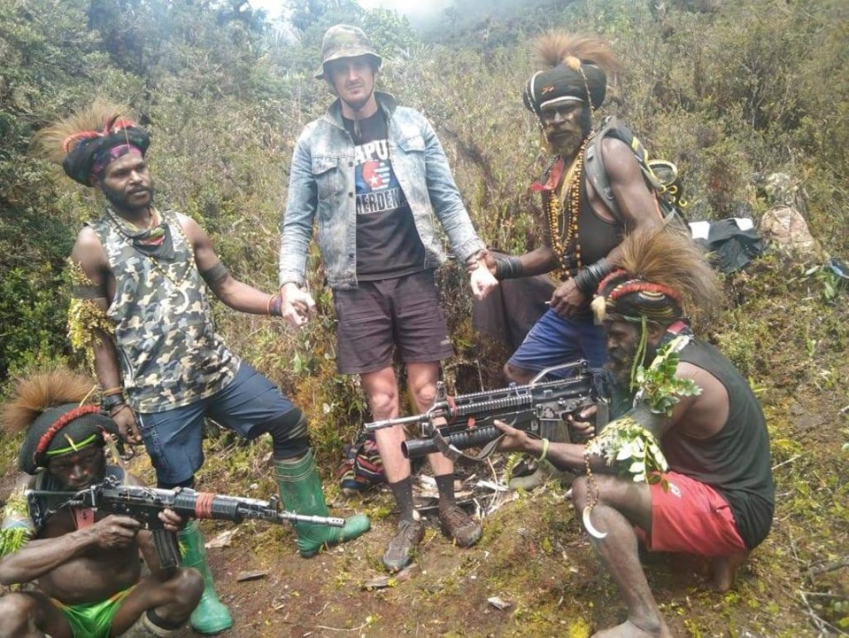 In this undated photo released by West Papua Liberation Army, the armed wing of the Free Papua Movement, Papuan separatist rebels pose for a photo with a man they said is New Zealander pilot Phillip Mark Mehrtens who they took hostage last week, at an undisclosed location in Papua province, Indonesia. Mehrtens, a pilot for Indonesian aviation company Susi Air, was abducted by the independence fighters who stormed his single-engine plane shortly after it landed on a small runway in Paro in remote Nduga district. (West Papua Liberation Army via AP)