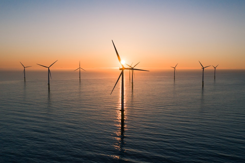 Offshore wind turbines at sunset.