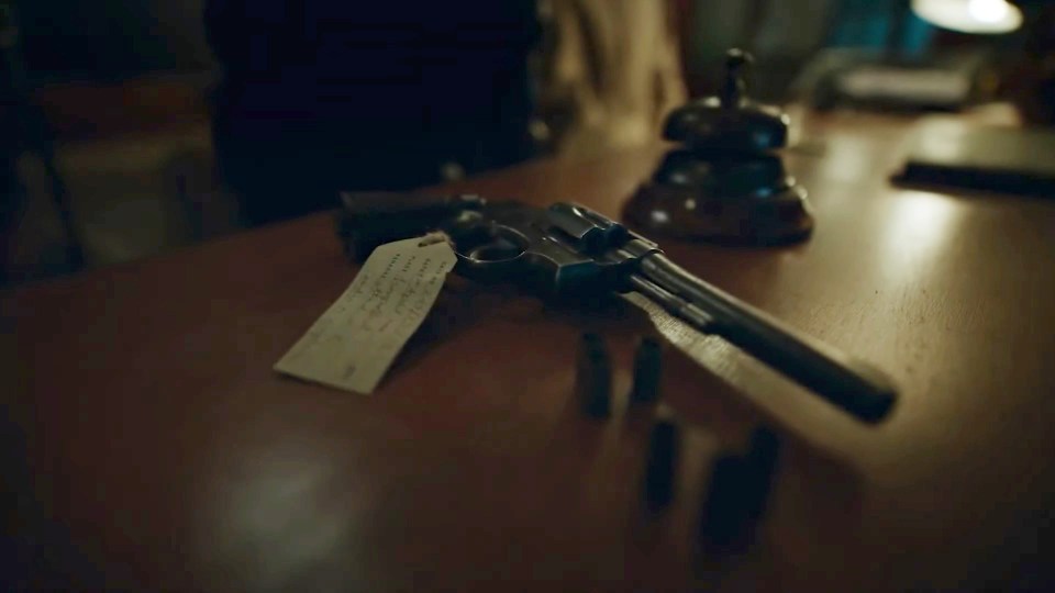 Revolver and bullets on a table.