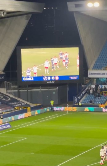 Soccer game shown on a jumbotron at a stadium.