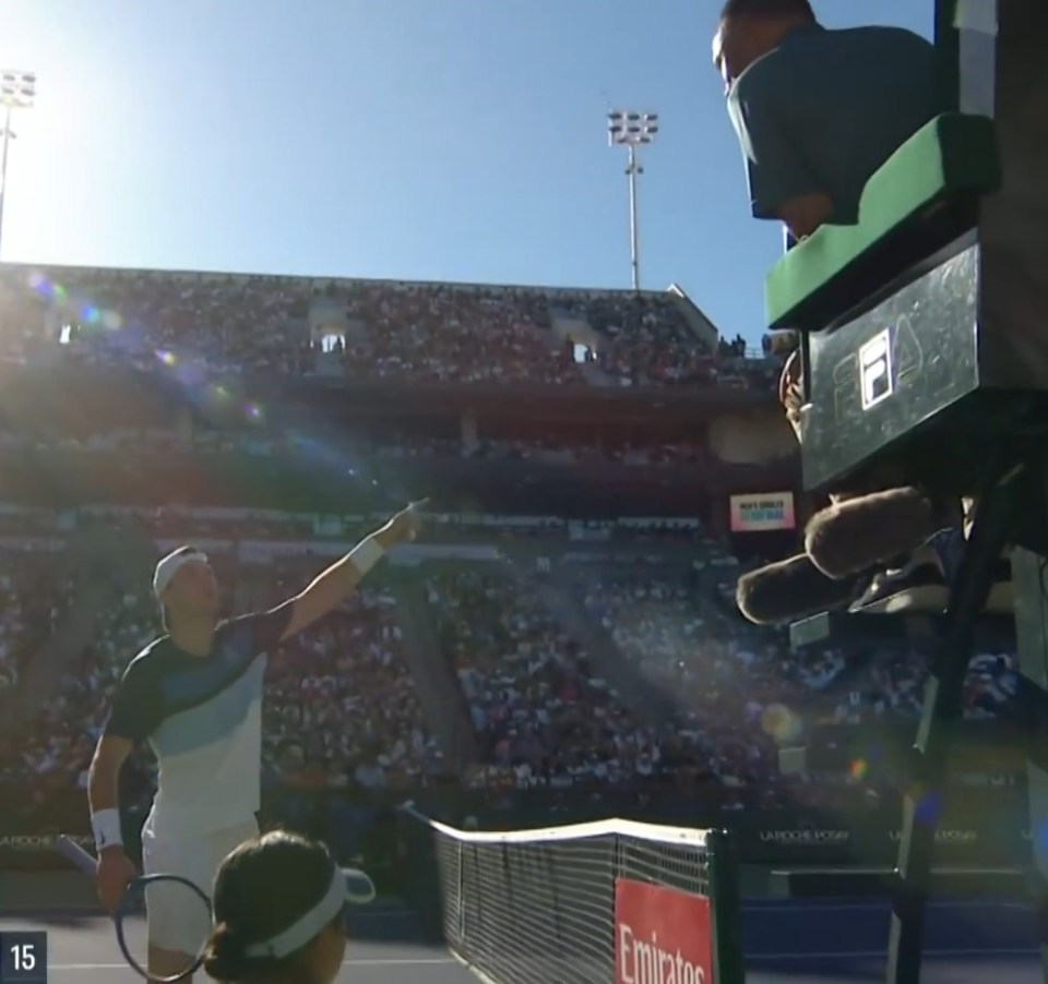 Tennis player challenging a line call.