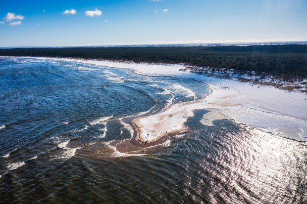 Aerial view of a snow-covered beach and ocean.