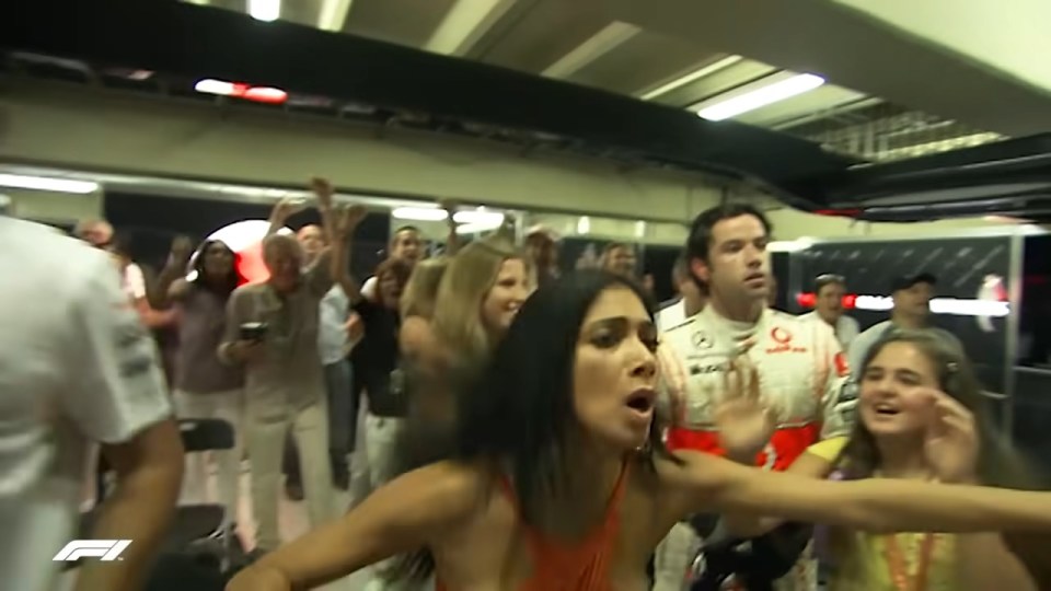 Lewis Hamilton celebrating his 2008 Brazilian Grand Prix win with fans.