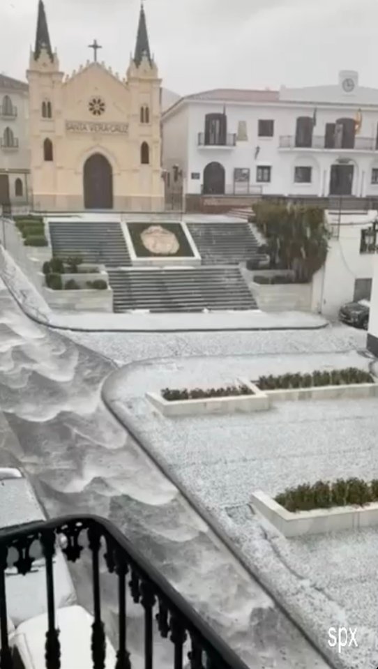 Hailstorm in Alhaurín el Grande, Spain, covering streets and a plaza.