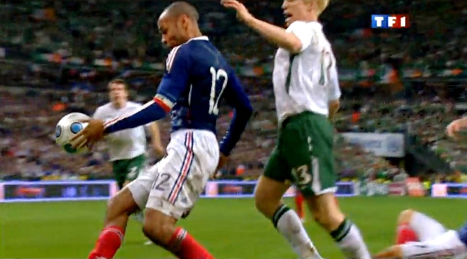 TV grab shows French forward Thierry Henry (L) eyes the ball next to Irish Paul Mc Shane during the World Cup 2010 qualifying football match France vs. Republic of Ireland on November 18, 2009 at the Stade de France in Saint-Denis, northern Paris. Superstar Thierry Henry was at the centre of a sensational cheating storm as France reached the World Cup finals along with Portugal, Greece and Slovenia. France, the 1998 champions and 2006 runners-up, drew 1-1 with Ireland at the Stade de France in the second leg of their play-off for a 2-1 aggregate win. But the extra-time triumph came in controversial circumstances when French skipper Henry appeared to control the ball with his hand before his angled pass allowed William Gallas to head in the crucial 103rd-minute goal. AFP PHOTO GRAB / TF1 / (Photo credit should read OFF/AFP/Getty Images)