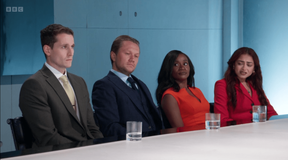 Screenshot of four people sitting at a table.