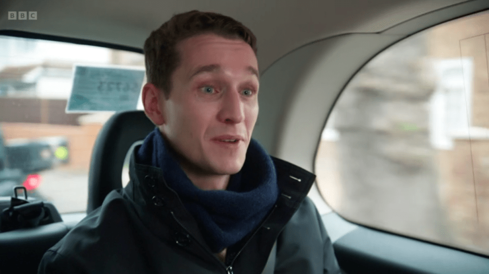 Man in a car speaking.
