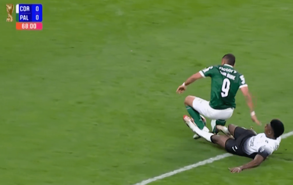Screenshot of a soccer game, showing a player on the ground after a tackle.