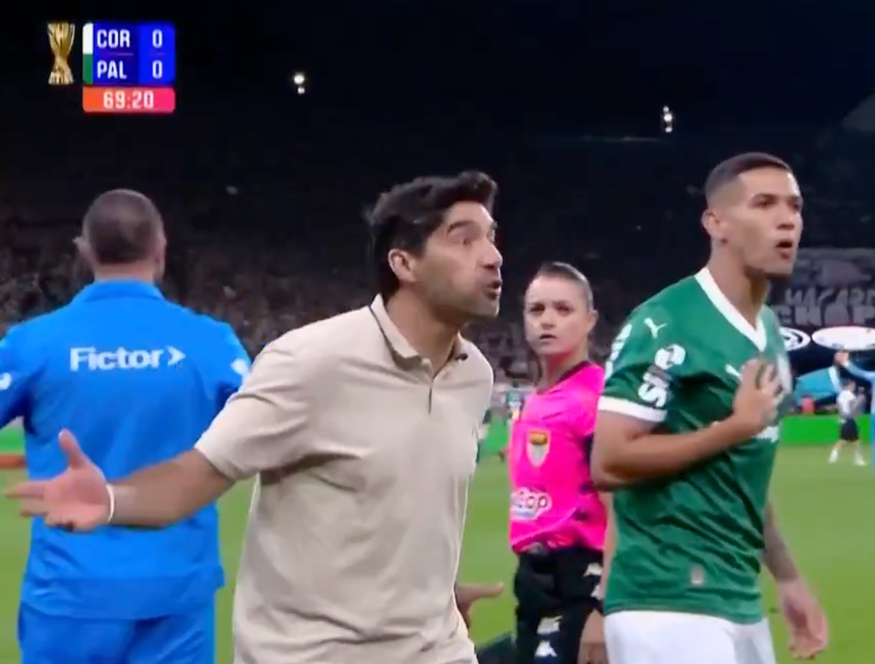 Screenshot of a soccer game, showing a coach arguing with a player and a referee.  The scoreboard shows a 0-0 tie at 69:20.