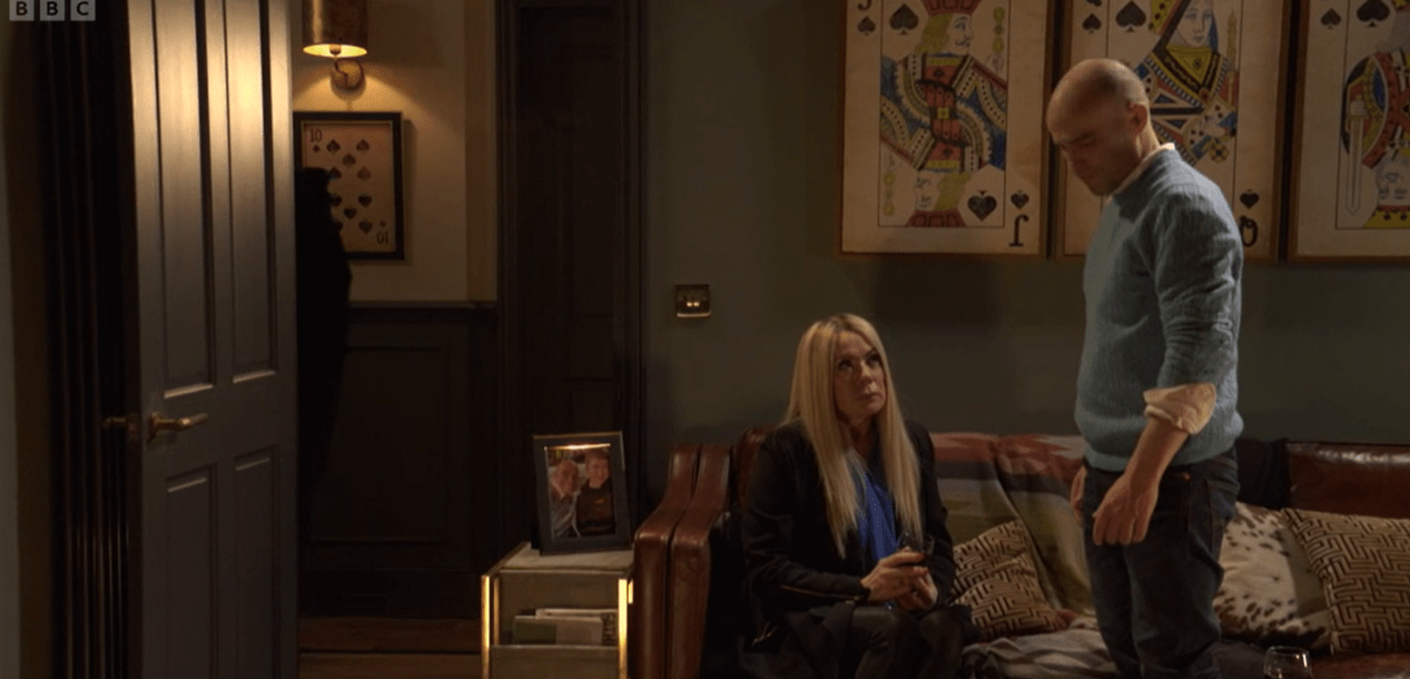 Screenshot of a man and woman in a living room.