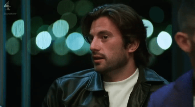 Man in leather jacket speaking.