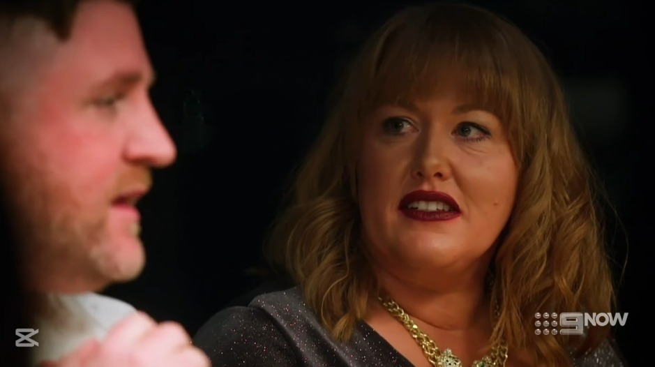 Screenshot of a man and woman in conversation.