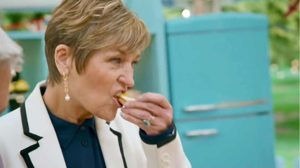 Woman taking a bite of food.
