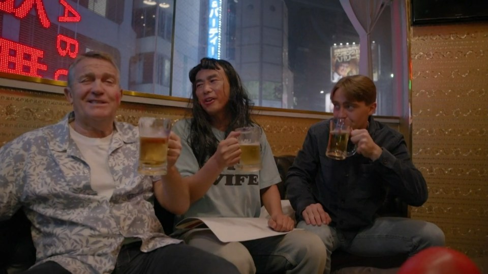 Three men drinking beer in a bar.