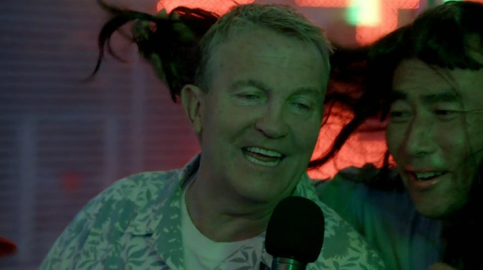 Two men singing karaoke.