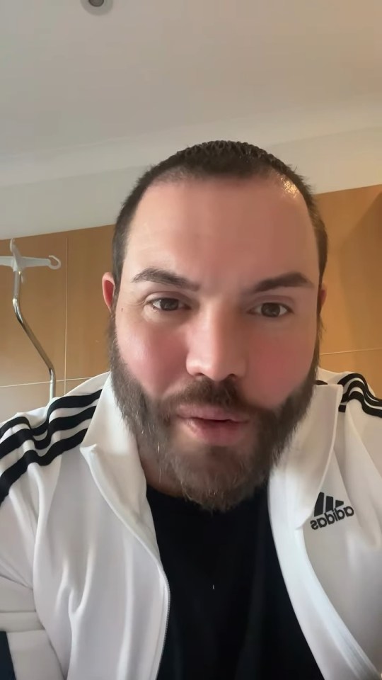 Close-up of a man in an Adidas jacket.