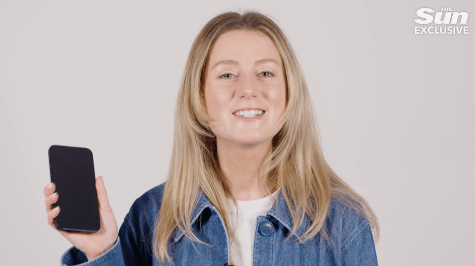 Woman holding up a smartphone.