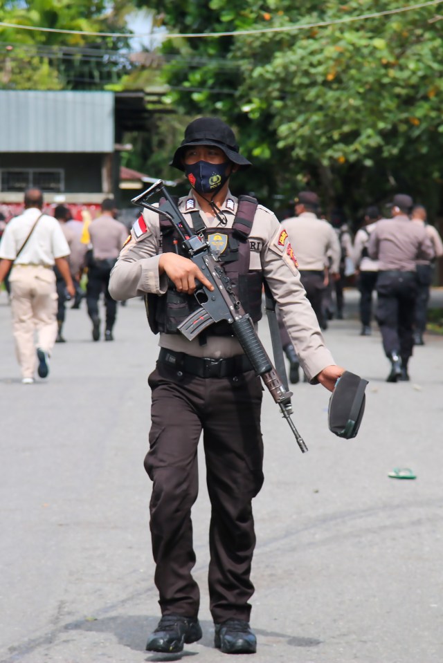 Armed policeman securing an area after activists were detained.