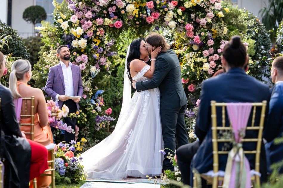 Ashleigh and Jake kissing at their wedding ceremony.