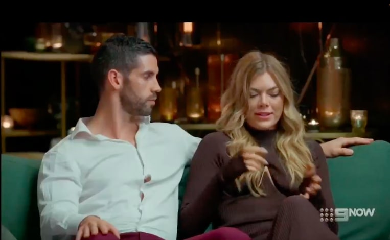 Ryan and Jacqui sitting on a couch with Alessandra.